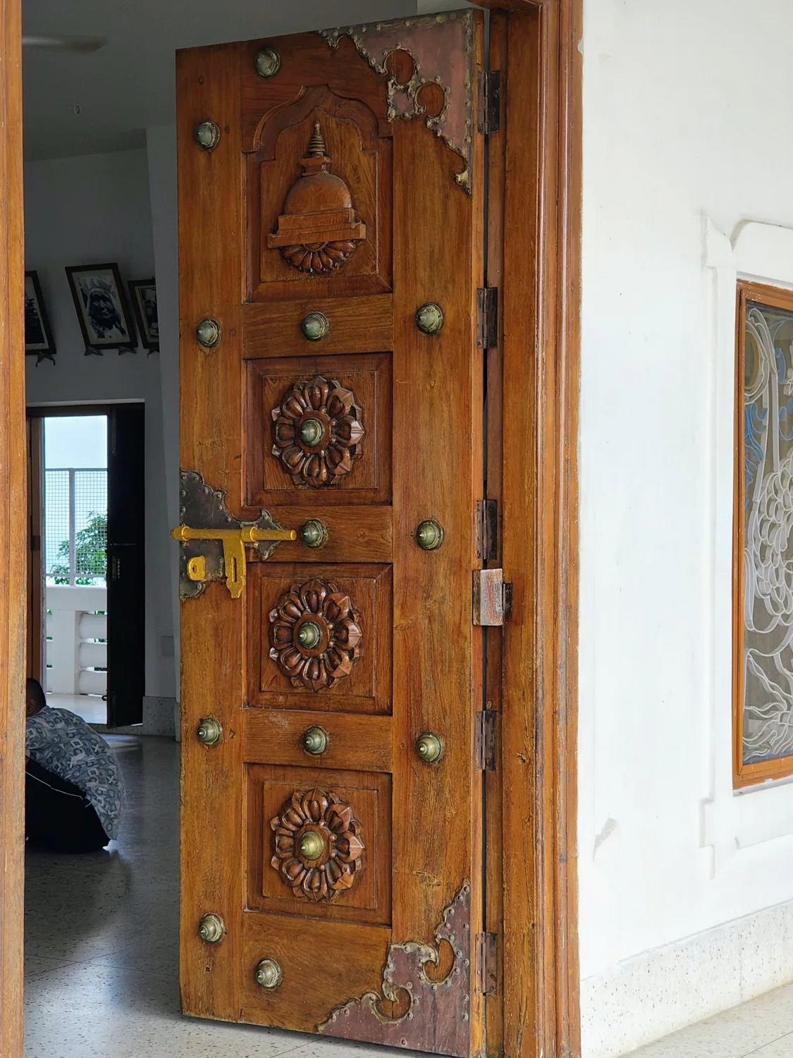 Tall solid wood entrance door with handcrafted carved geometric detail