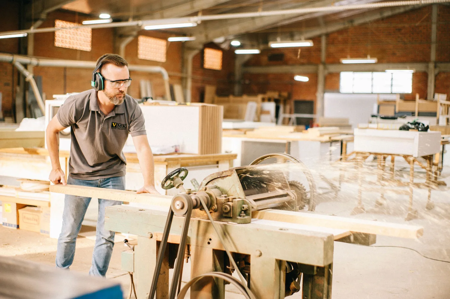 Woodworking workshop using precision machinery to shape solid wood components