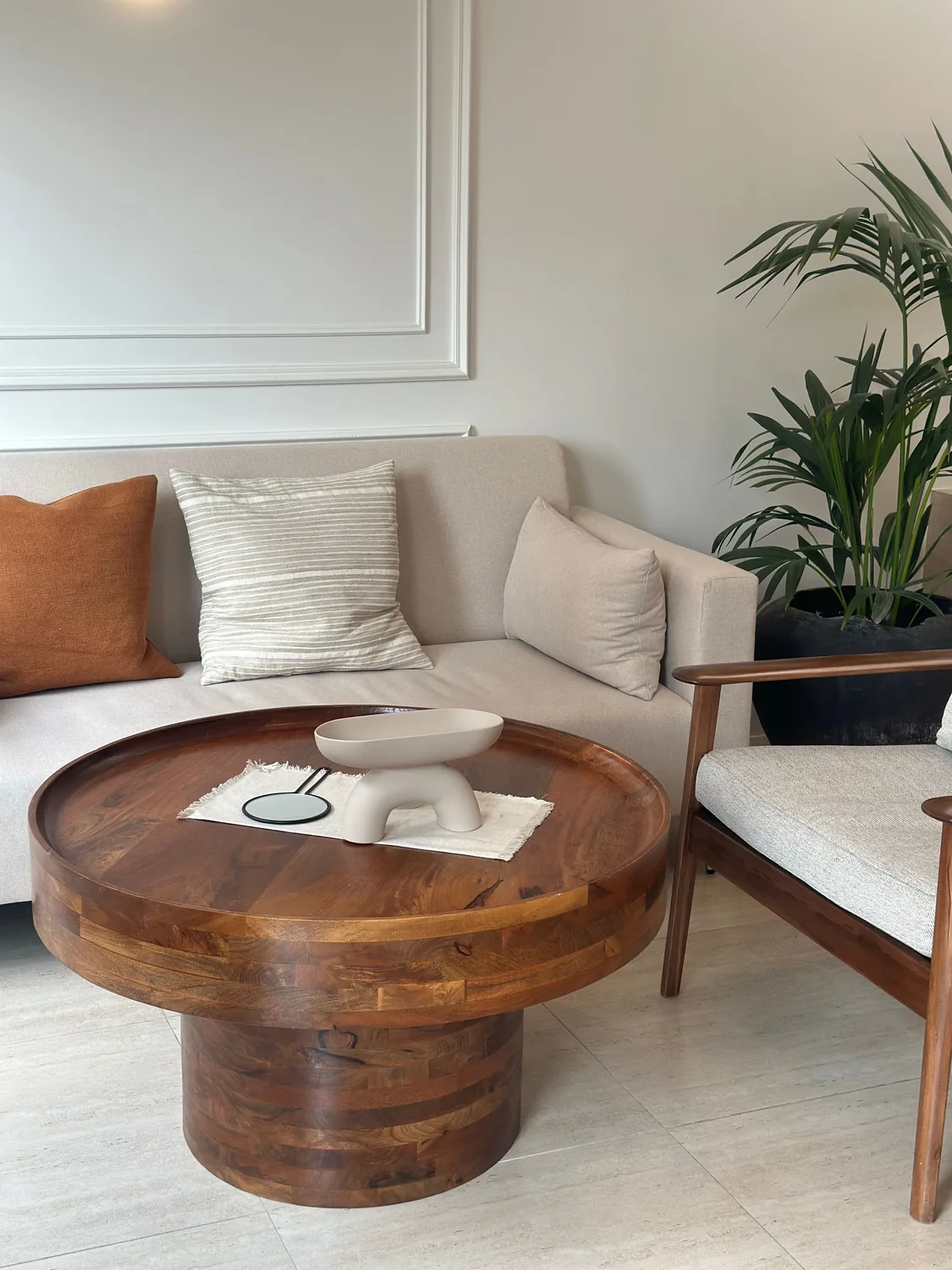 Round solid wood coffee table with a warm natural finish