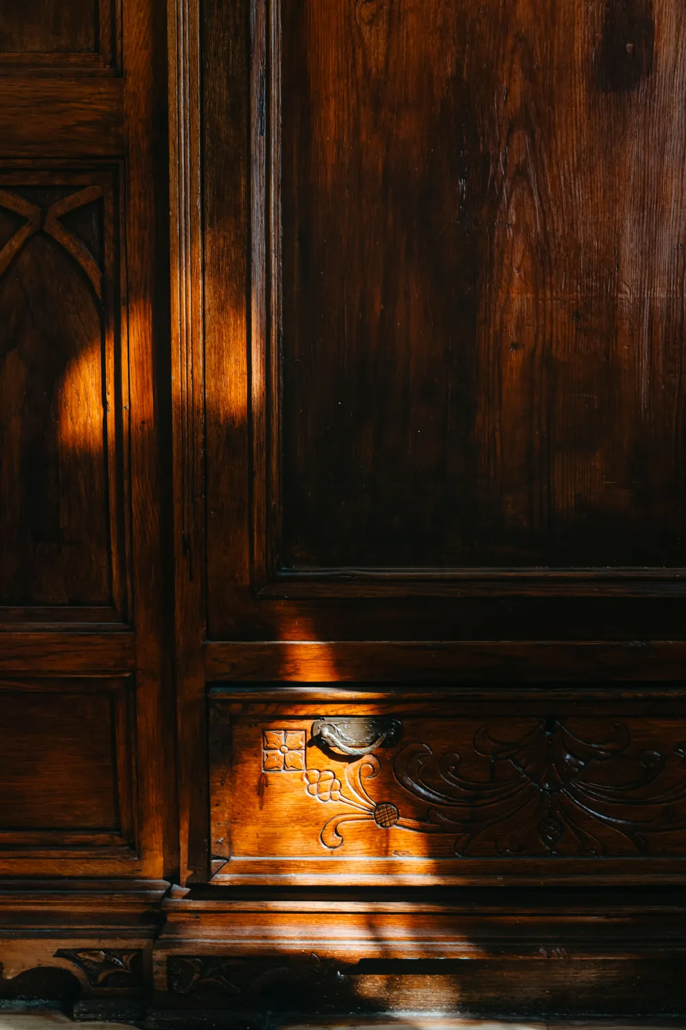 Artisan hand-carving a detailed pattern into solid wood